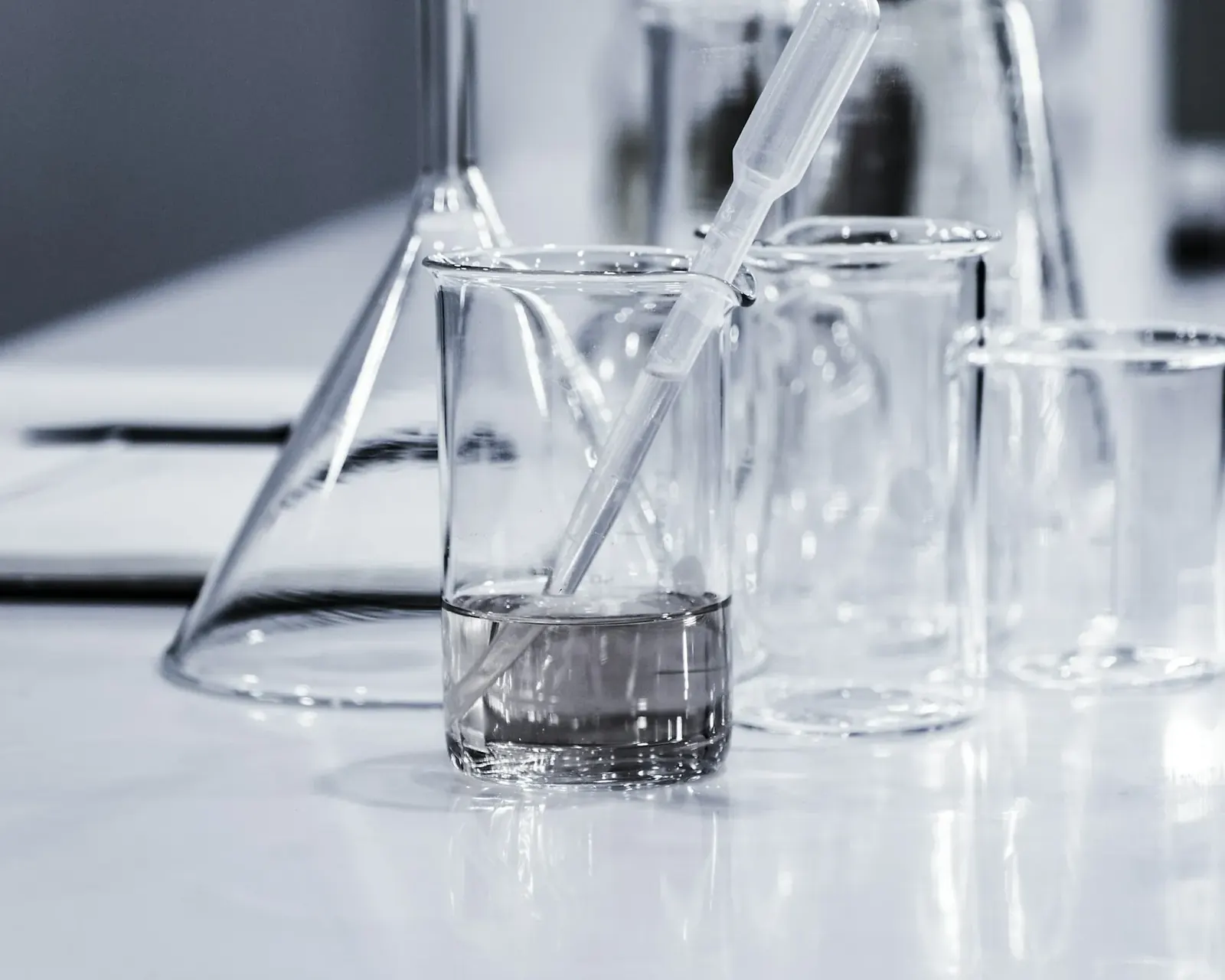 Laboratory glassware with water samples on a white bench