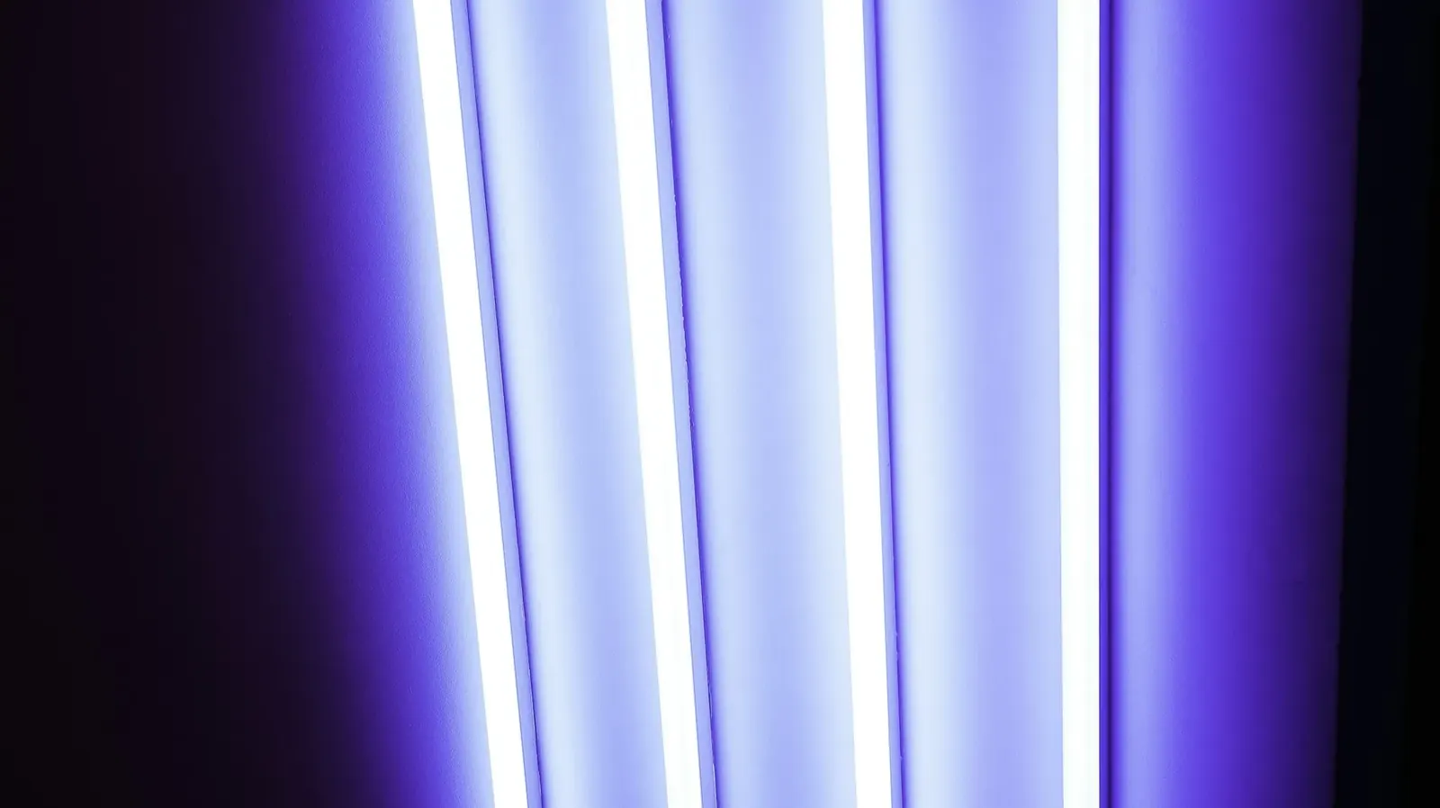 Violet ultraviolet tubes glowing in darkness